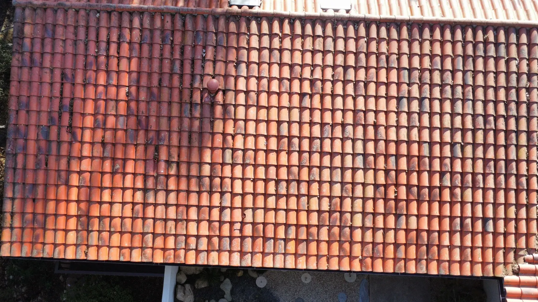 The same roof tiles after soft washing, moss and lichen gone