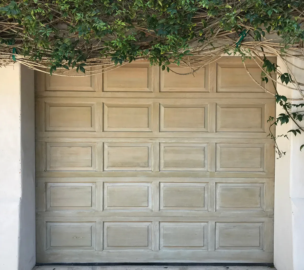 The same garage door after soft washing, mildew removed and the original color restored